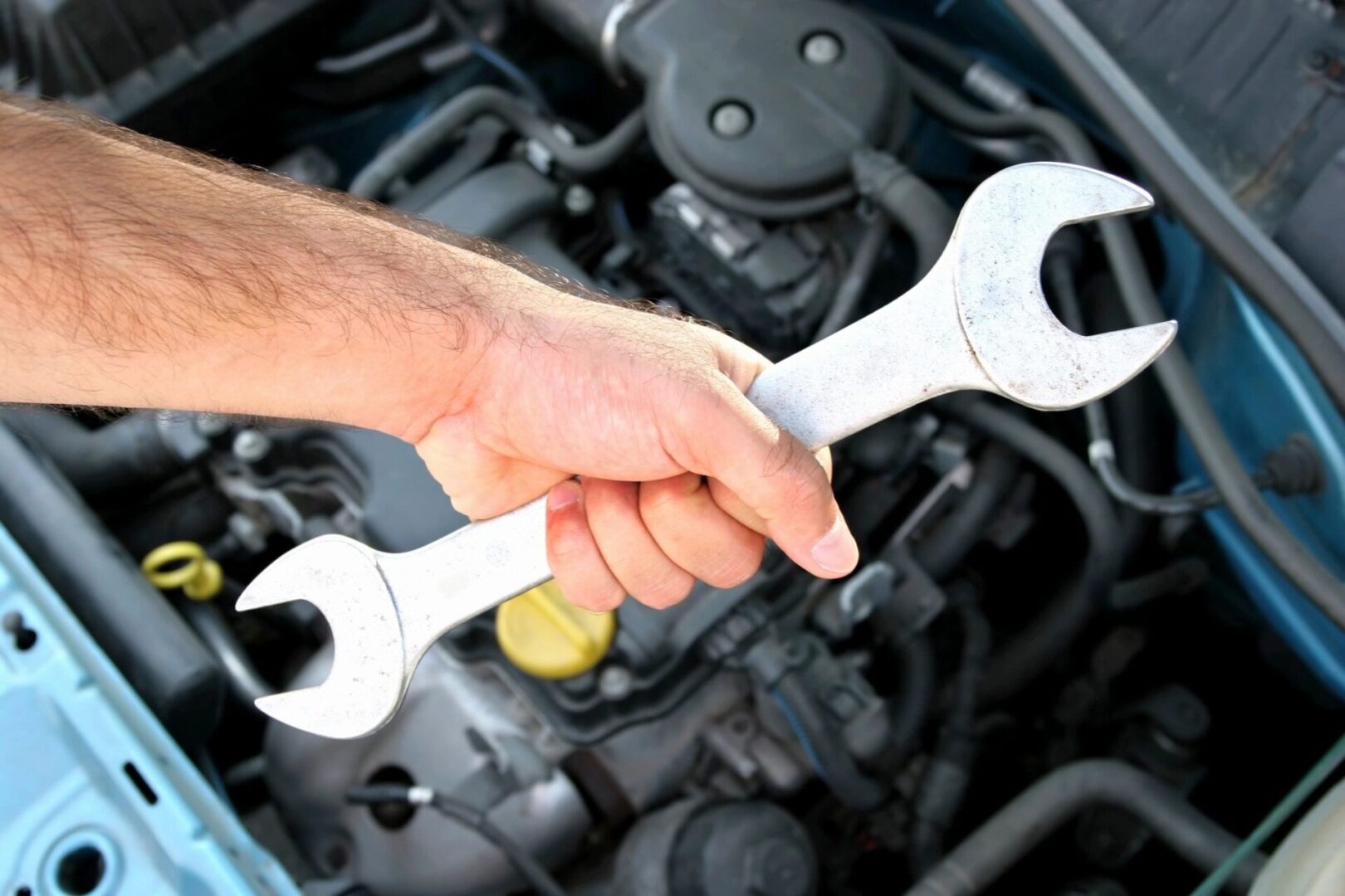 A mechanic holding big tools